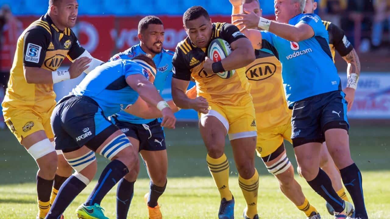 Ngani Laumape (C) of the Hurricanes in action against the Bulls