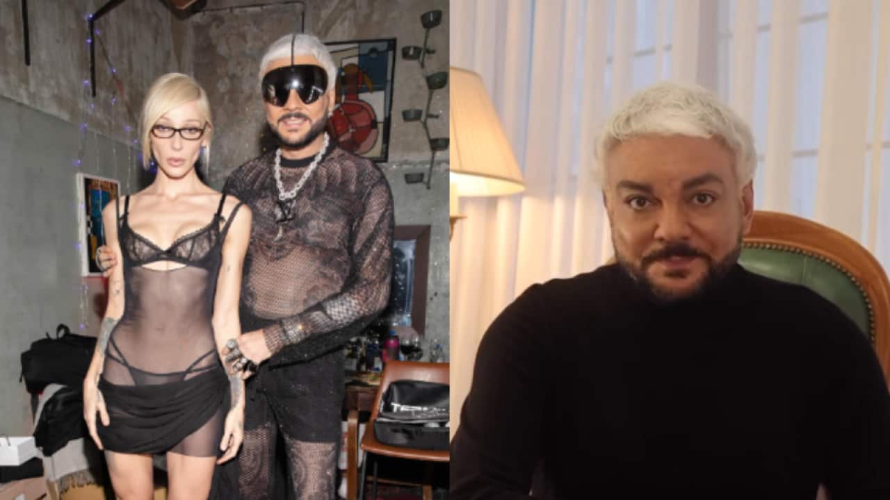 A man and a woman dressed in black are at the party, and the man is wearing a black jumper.