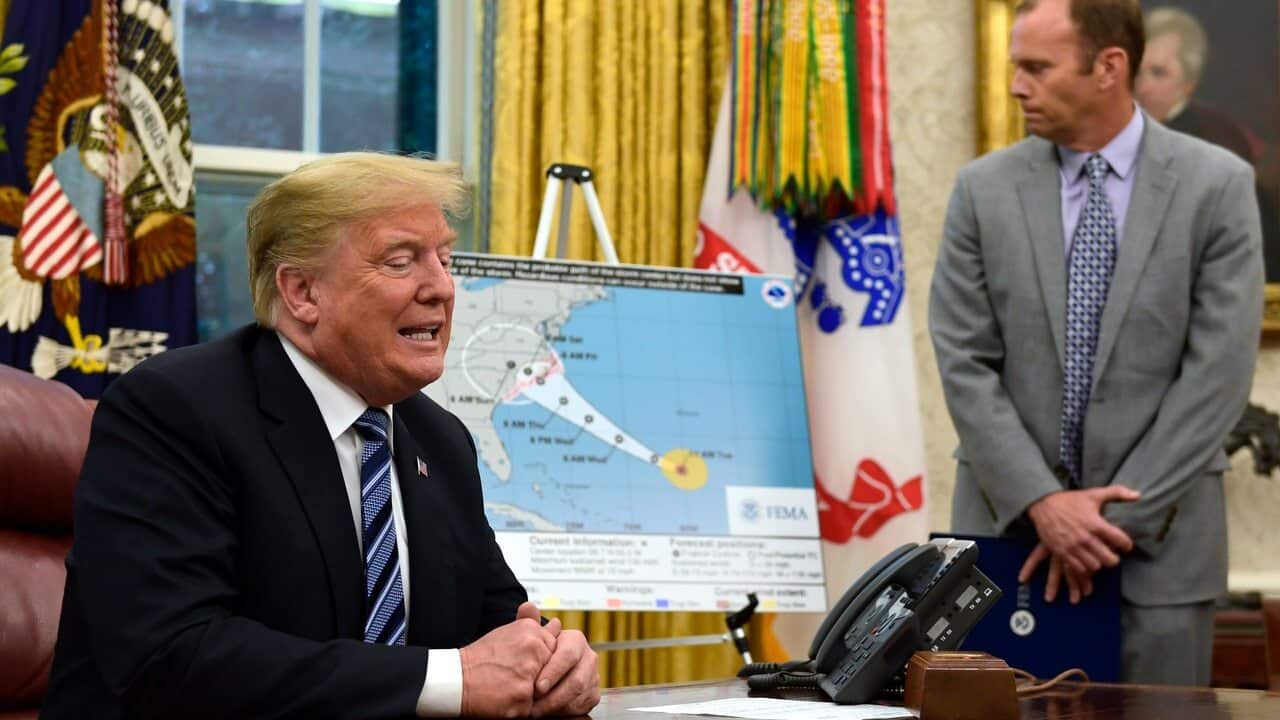 President Donald Trump, left, talks about Hurricane Florence during a briefing in the Oval Office of the White House.