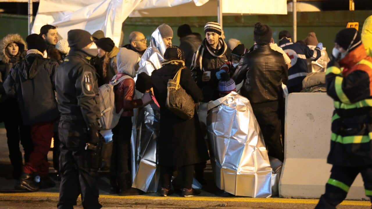 Smugglers who bring migrants to Europe by sea appear to have adopted a new, more dangerous tactic: cramming hundreds of them onto a large cargo ship, setting it on an automated course to crash into the coast, and then abandoning the helm. (AAP)