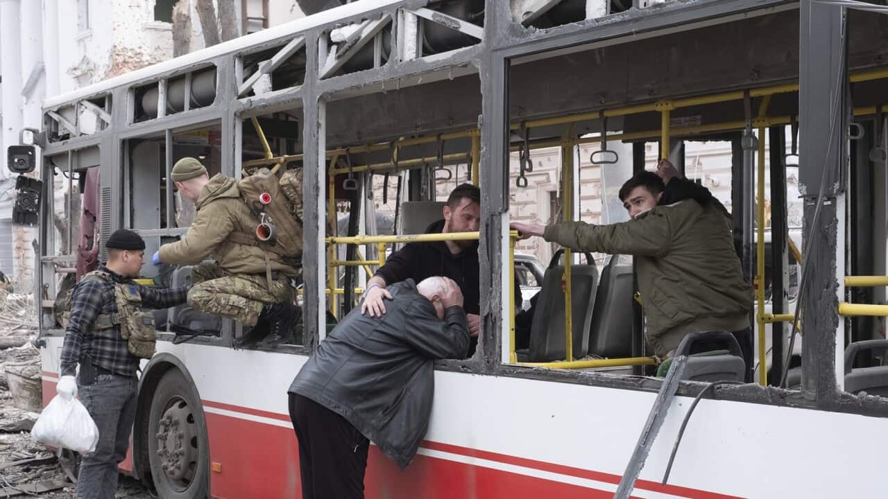 A man cries as he leans on the bus that was hit by a Russian missile on Sumy, Ukraine (AAP).
