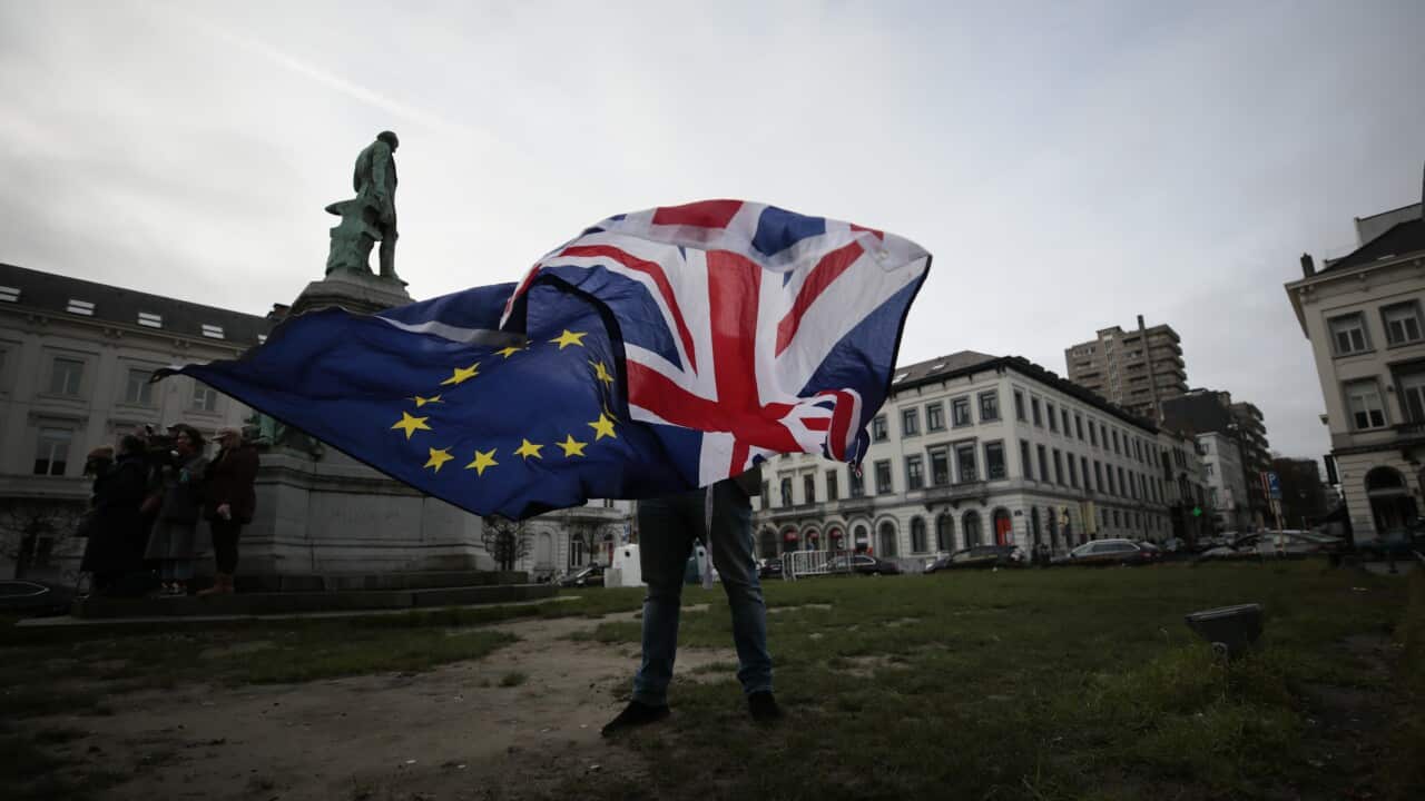 Pro-EU supporter Peter Cook unfurls a Union and EU flag prior to a ceremony to celebrate British and EU friendship.