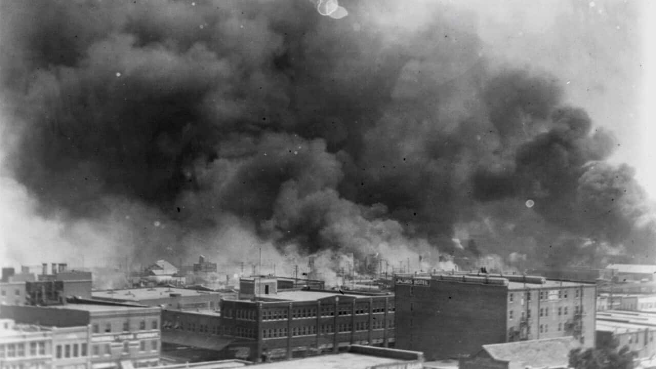 In this 1921 image provided by the Library of Congress, smoke billows over Tulsa, Oklahoma.