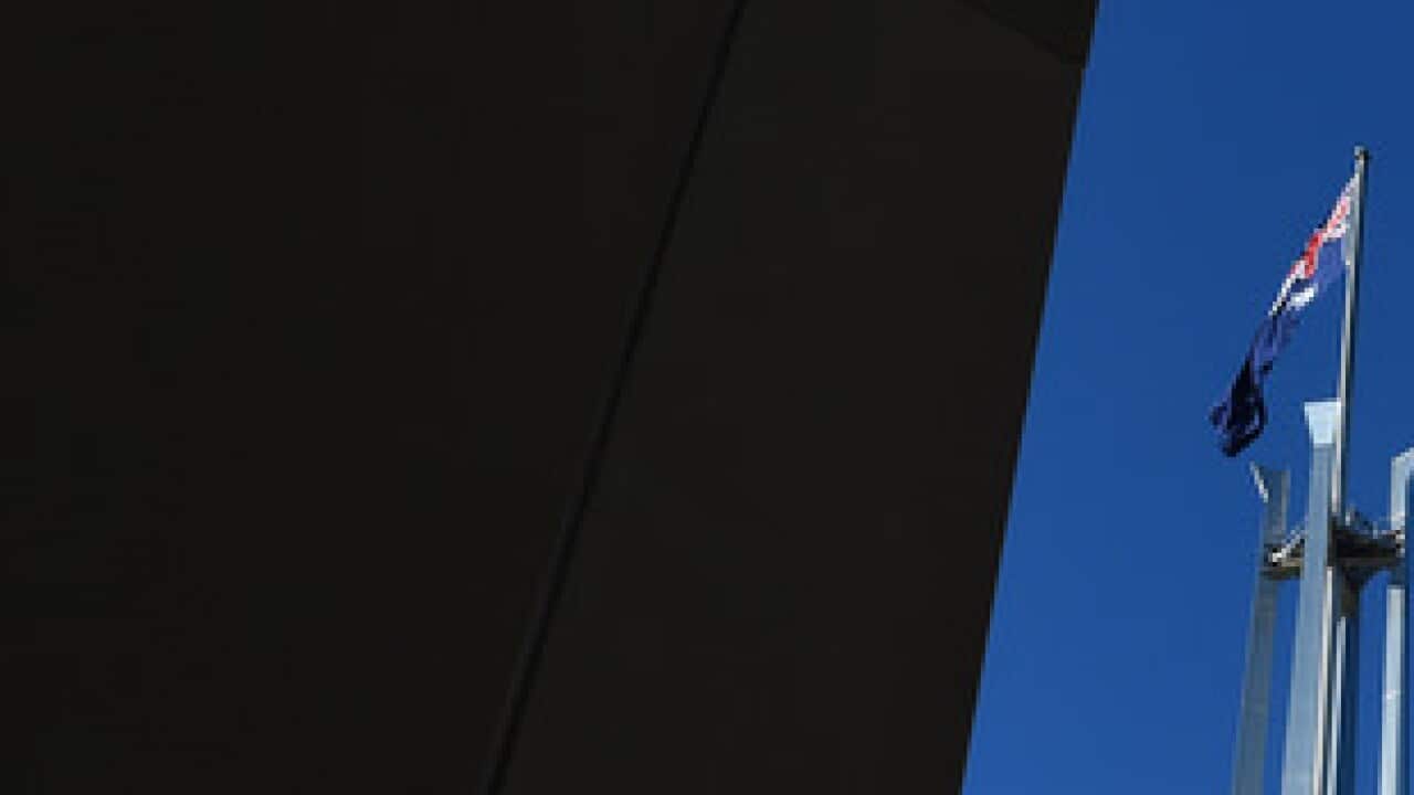 The Australian flag is seen above Parliament House in Canberra, Thursday, Aug. 13, 2015. (AAP Image/Mick Tsikas) NO ARCHIVING