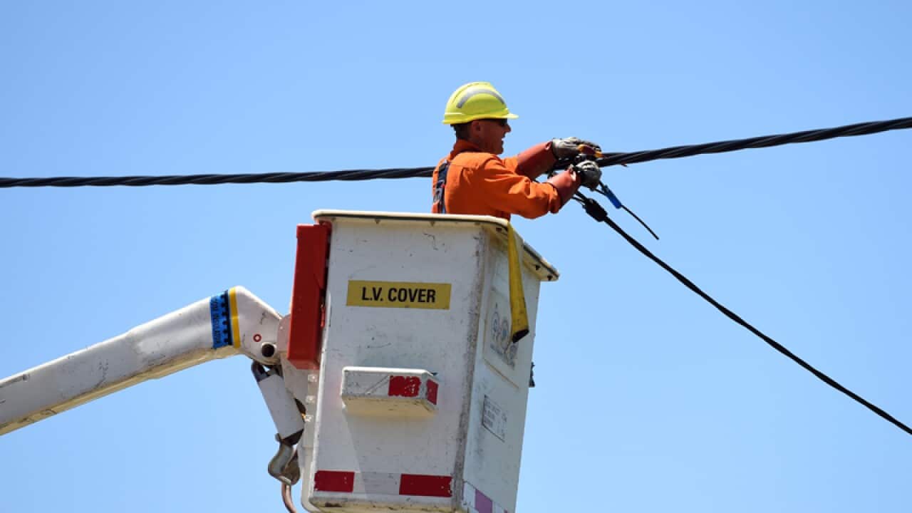 A workman works to restore electricity in Kurnell