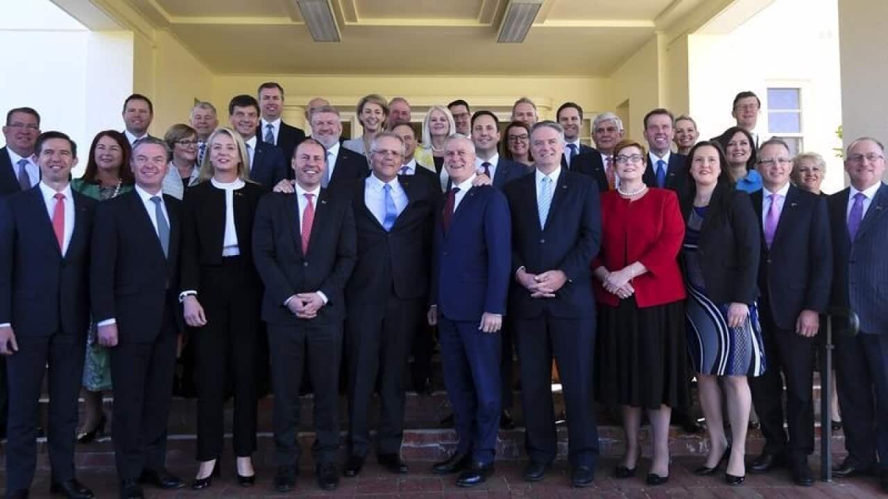 PM Scott Morrison poses for photographs with members of his ministry.
