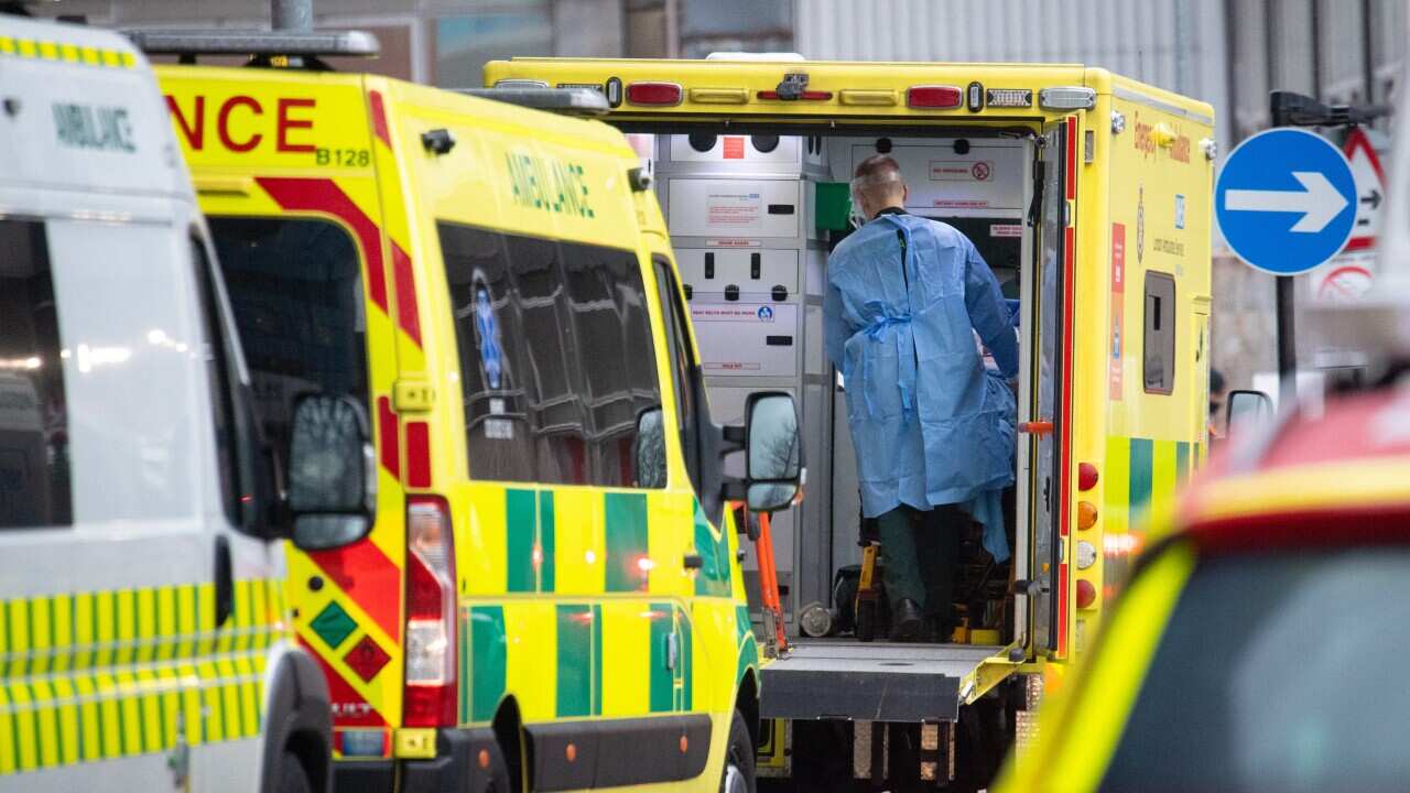A paramedic unloads a patient from an ambulance outside the Royal London hospital in London, Tuesday 5 January, 2021.