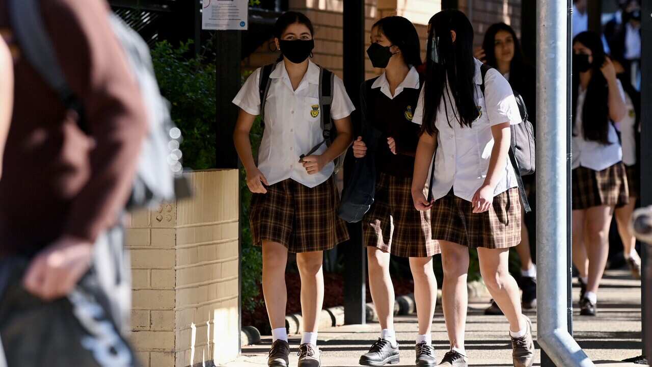 Students wear face masks to school.