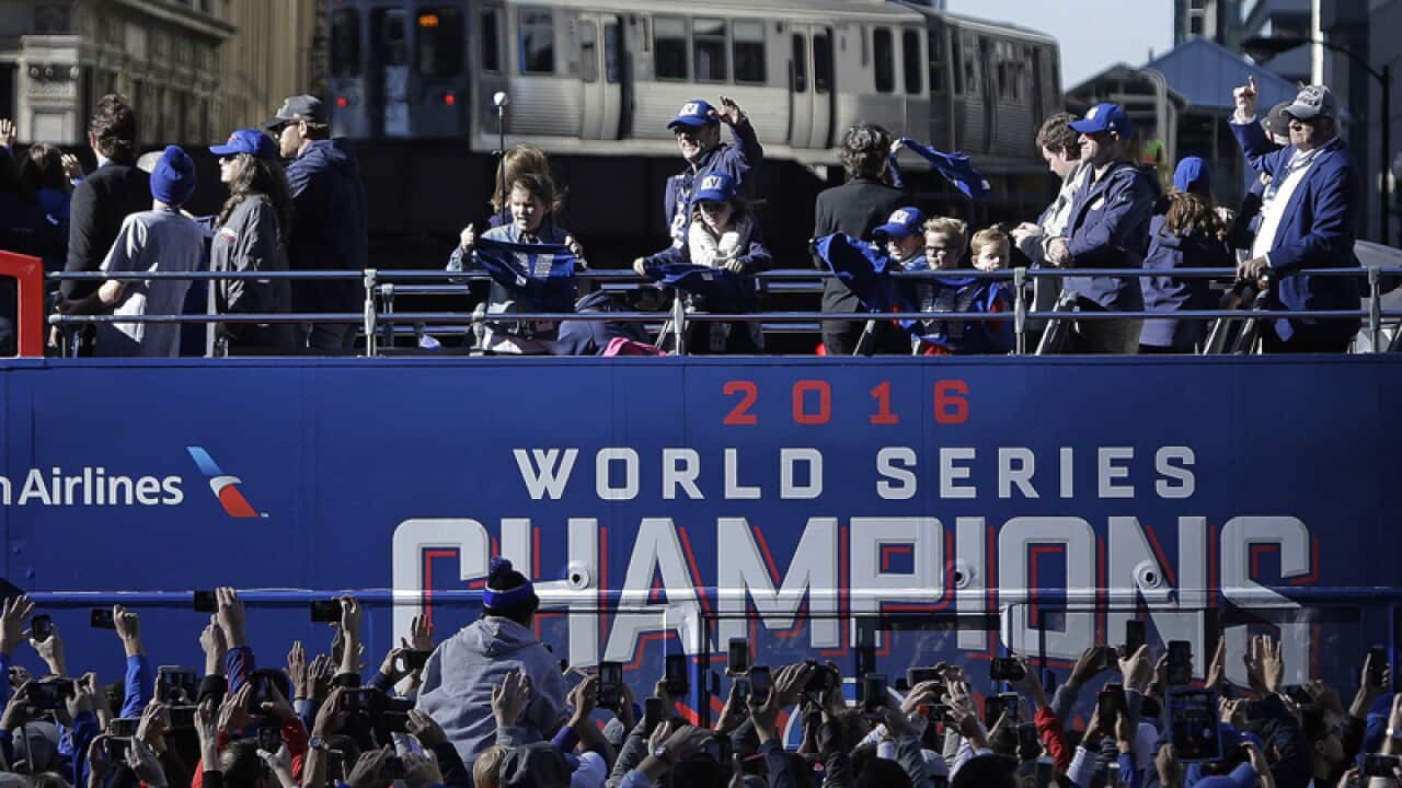 Chicago Cubs Chairman Tom Ricketts waves to fans