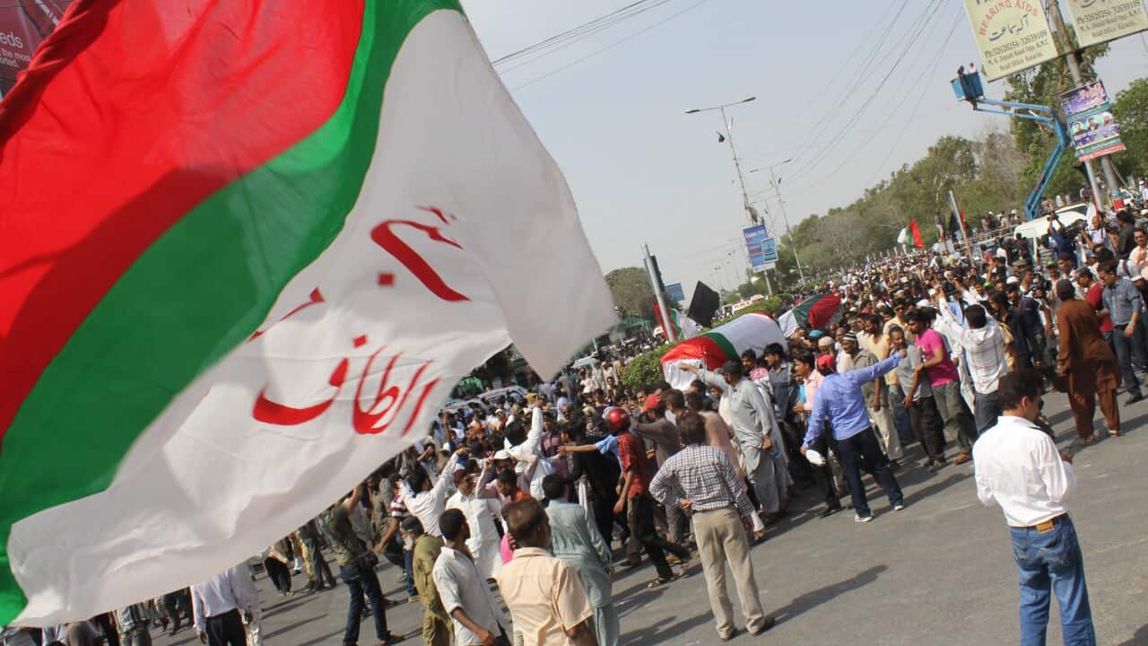 A flag is seen as the liberal, secular political party Muttahida Qaumi Movement (MQM) hold a funeral