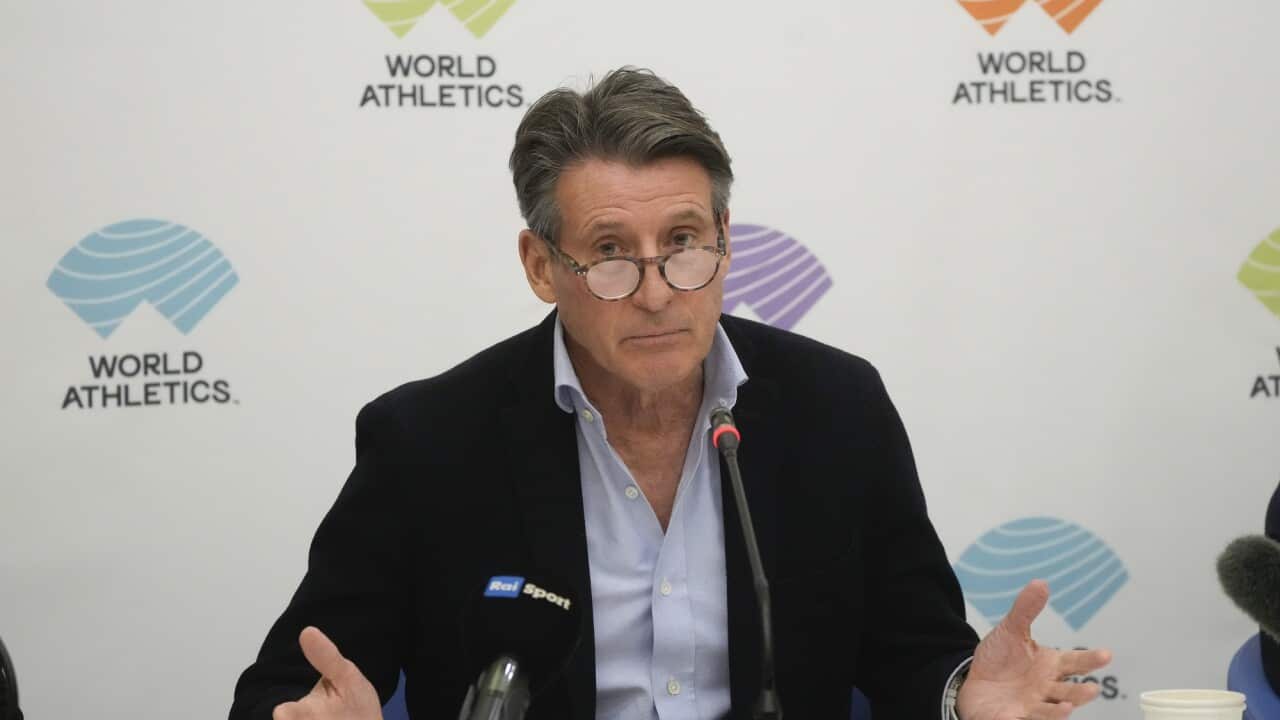 World Athletics President Sebastian Coe sits at a desk during a press conference