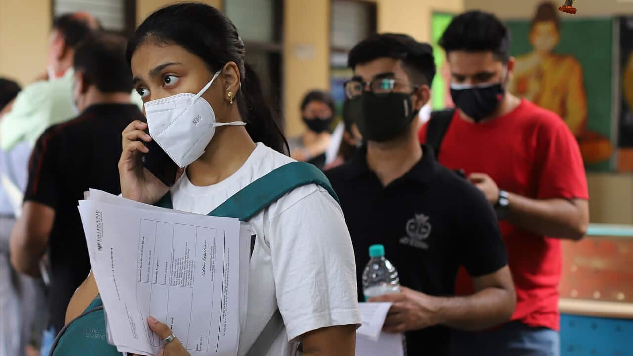 Students and international travelers in Delhi completing paperwork before being vaccinated against Covid-19 (