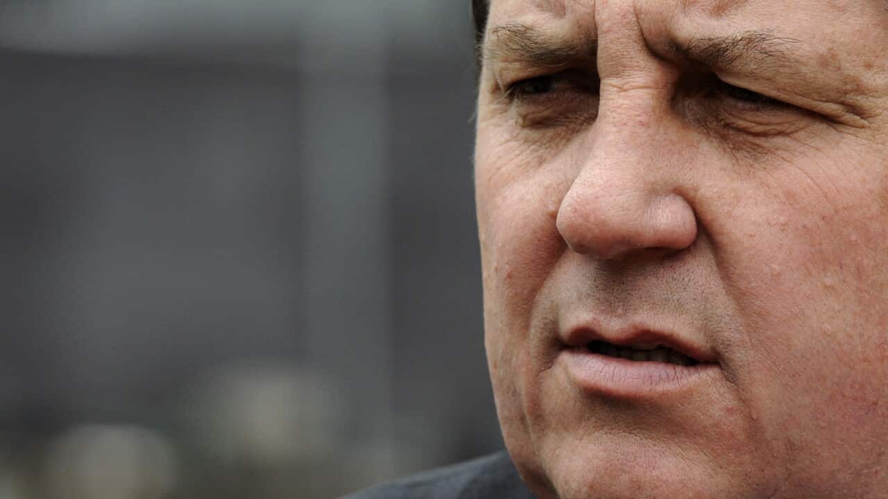 A close-up of a man looking to his right.