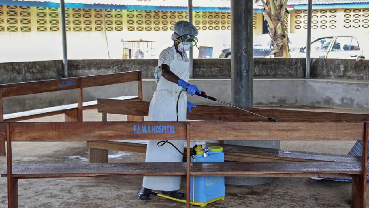A nurse sprays chemical disinfectants