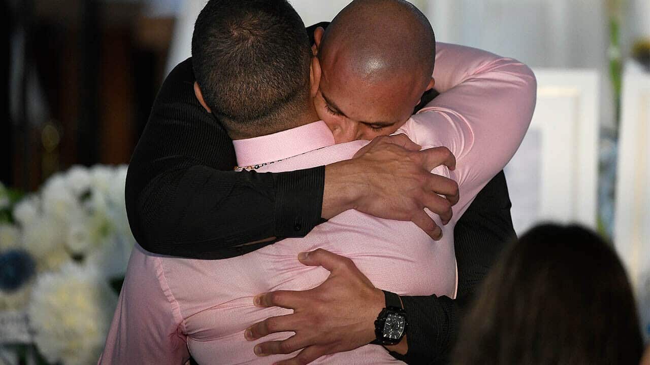 Danny Abdallah is comforted during the funeral for his children Anthony Abdallah, 13, Angelina Abdallah, 12, and Sienna Abdallah, 8.