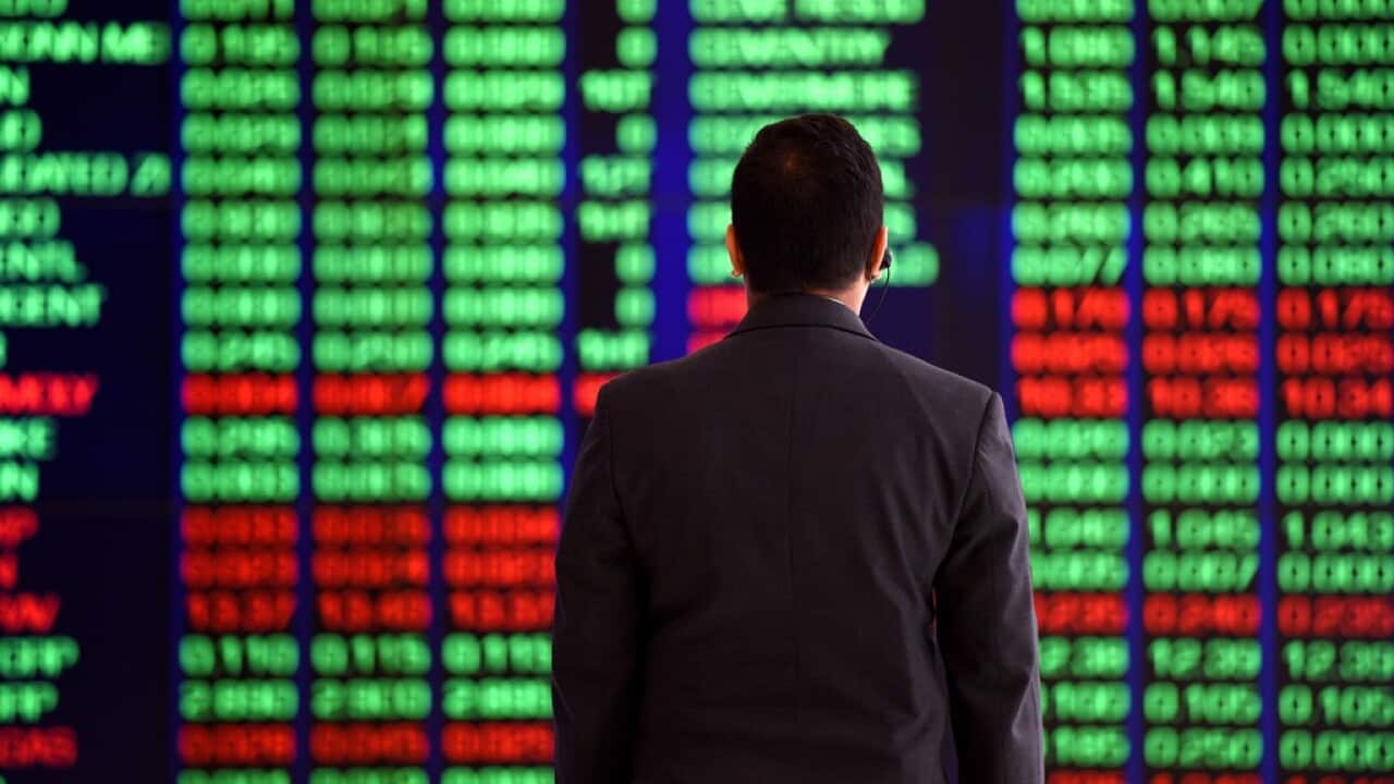 An attendant watches market gains, displayed on the ASX trading board in Sydney on Thursday, March 31, 2016. (AAP Image/Mick Tsikas) NO ARCHIVING