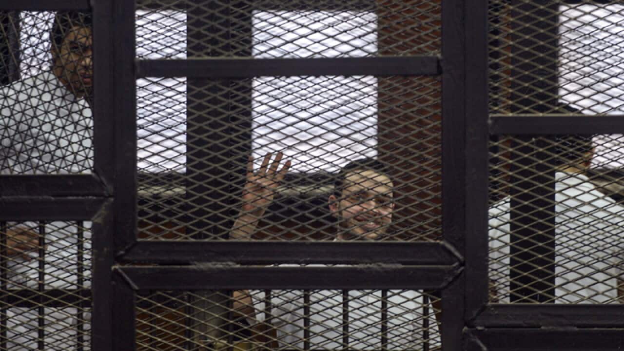 A defendant gestures in the accused cell