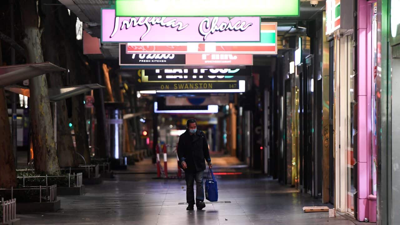 A man walks down Swanston Street after a citywide curfew is introduced in Melbourne.