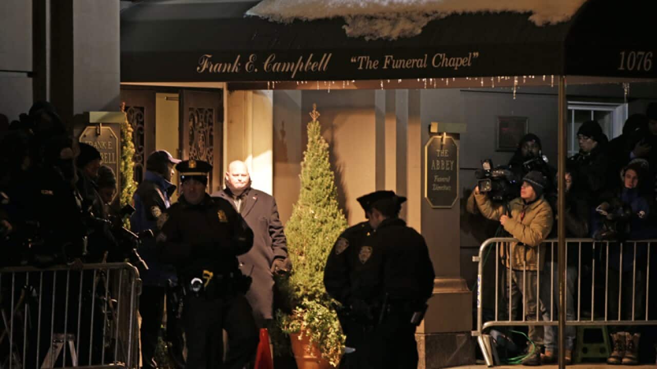 Police officers outside the Frank E. Campbell Funeral Home