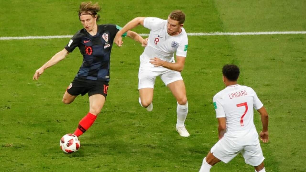 Croatia's Luka Modric works against England's Jordan Henderson.