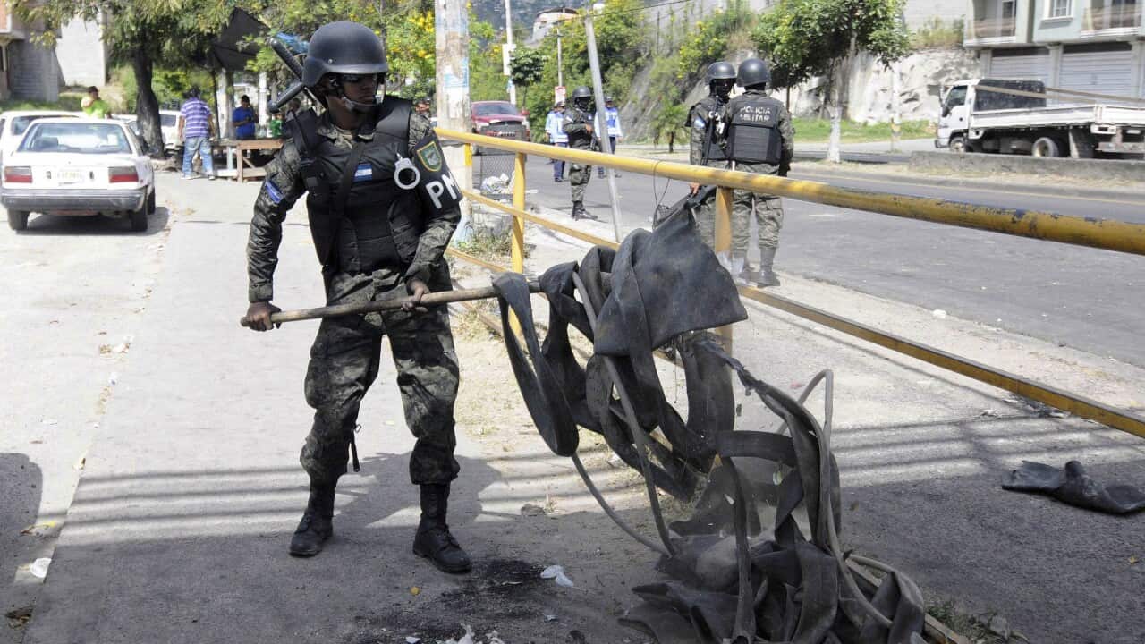Military personnel clean the streets after demonstrations in Tegucigalpa, Honduras.