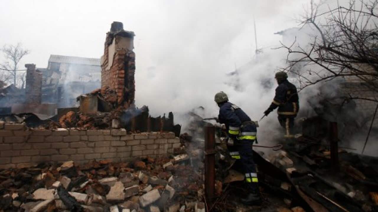 Firefighter inspect a fire in Avdiivka after heavy shelling by pro-Russian rebels on February 25, 2017