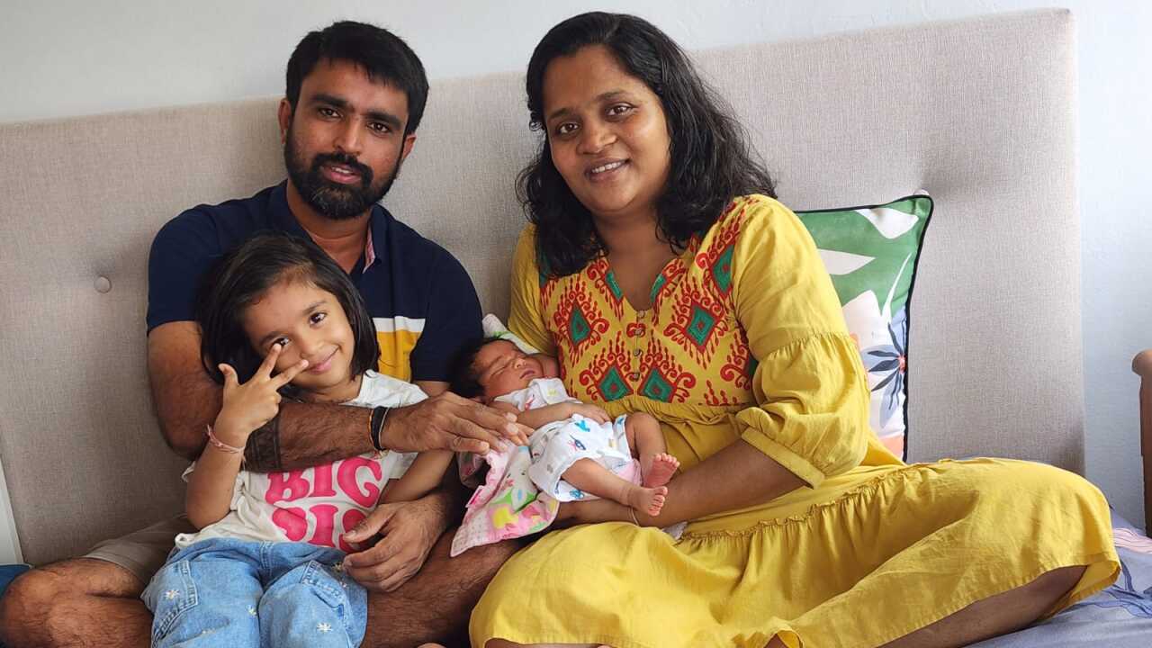 Mayur Patel (L) with his wife Punam Patel (R) and newborn daughter