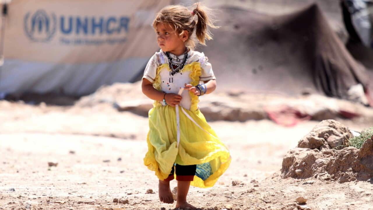 A displaced Afghan girl walks at a temporary shelter provided by the UNHCR on the outskirts of Herat, Afghanistan, 17 June 2019.