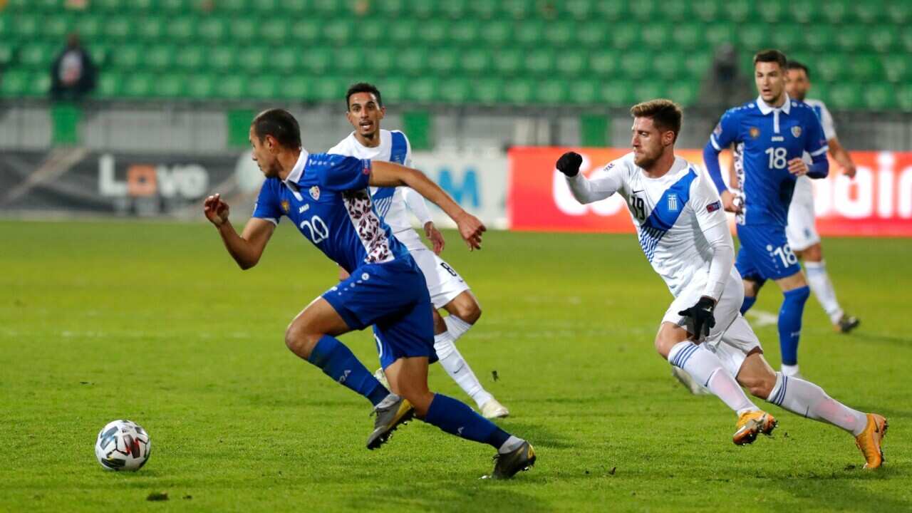 Moldova's Iaser Tsurcan (L) in action against Greece's Giorgos Kiriakopoulos (front R) during the UEFA Nations League soccer match between Moldova and Greece at Zimbru Stadium in Chisinau, Moldova, 15 November 2020.
