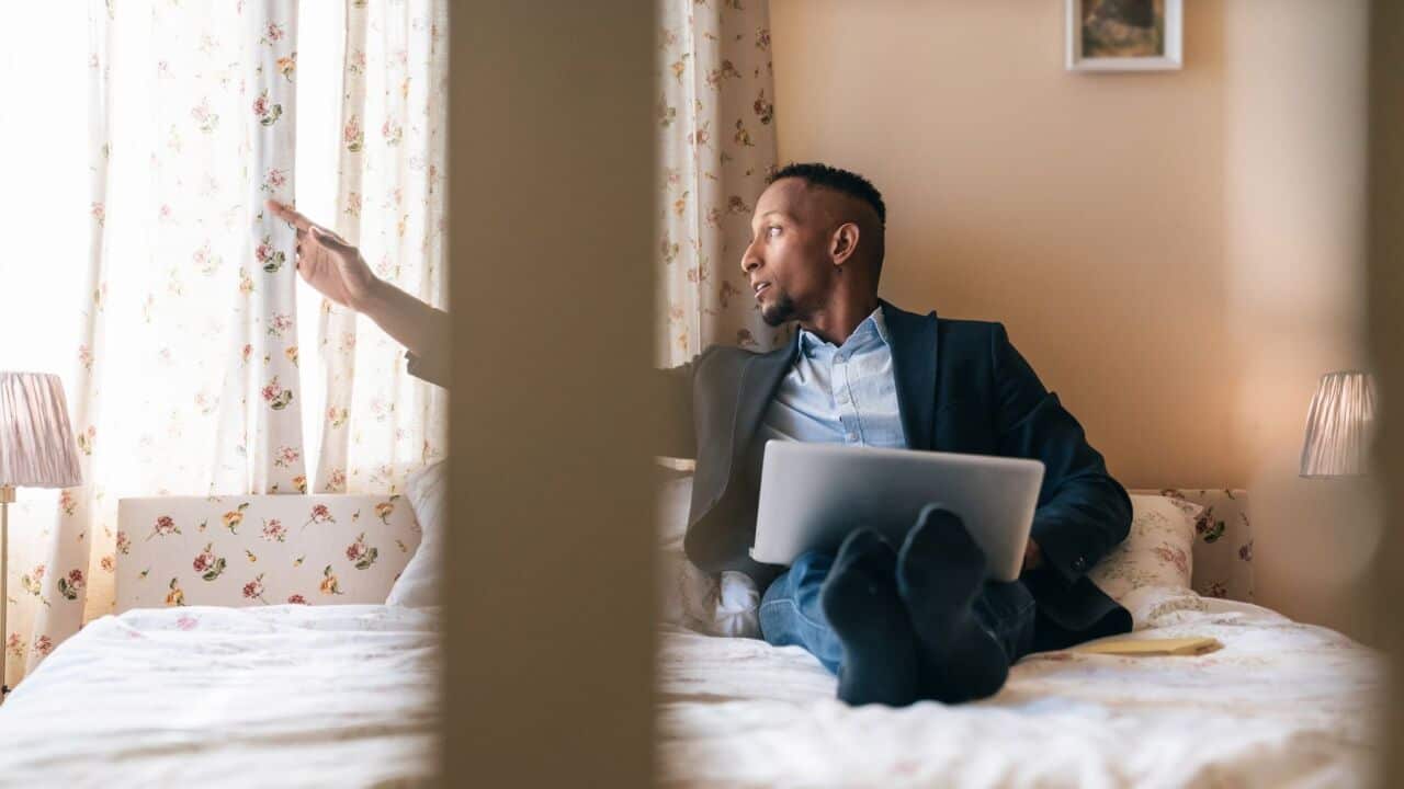 Businessman working in isolation in his hotel room in a state of emergency