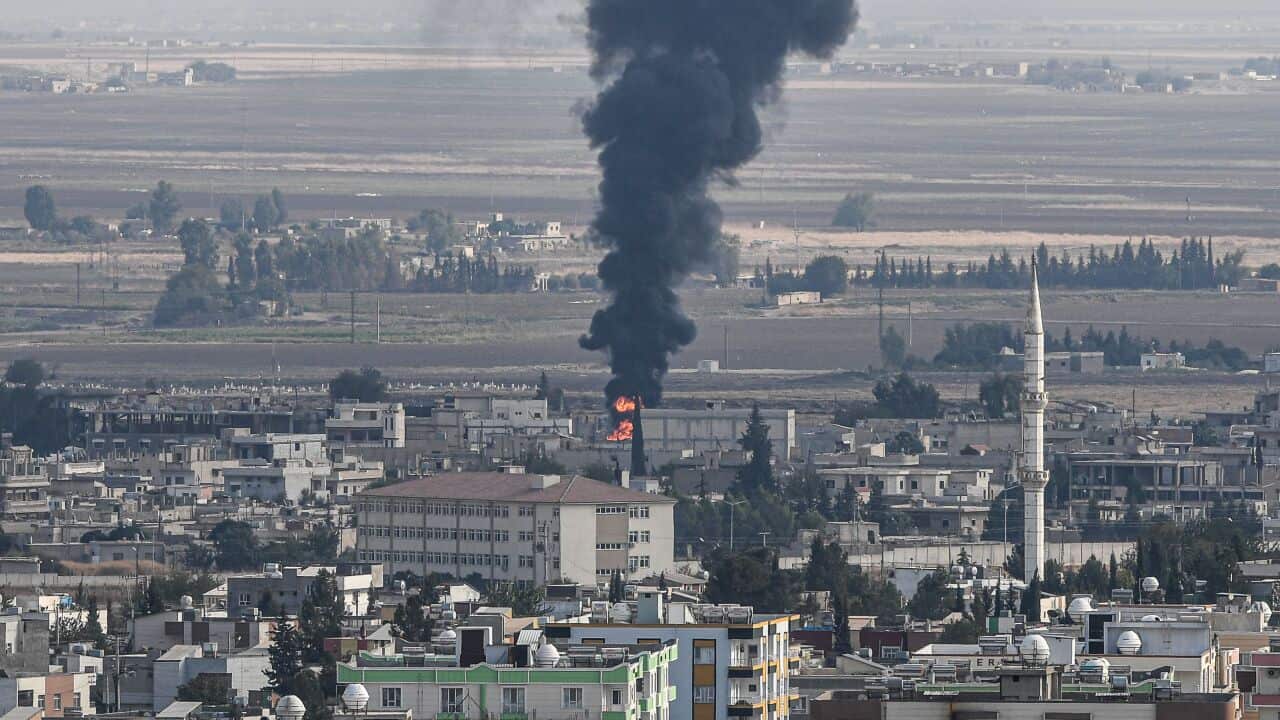 Fire and smoke rising from the Syrian town of Ras al-Ain on the first week of Turkey's military operation against Syrian Kurdish forces.