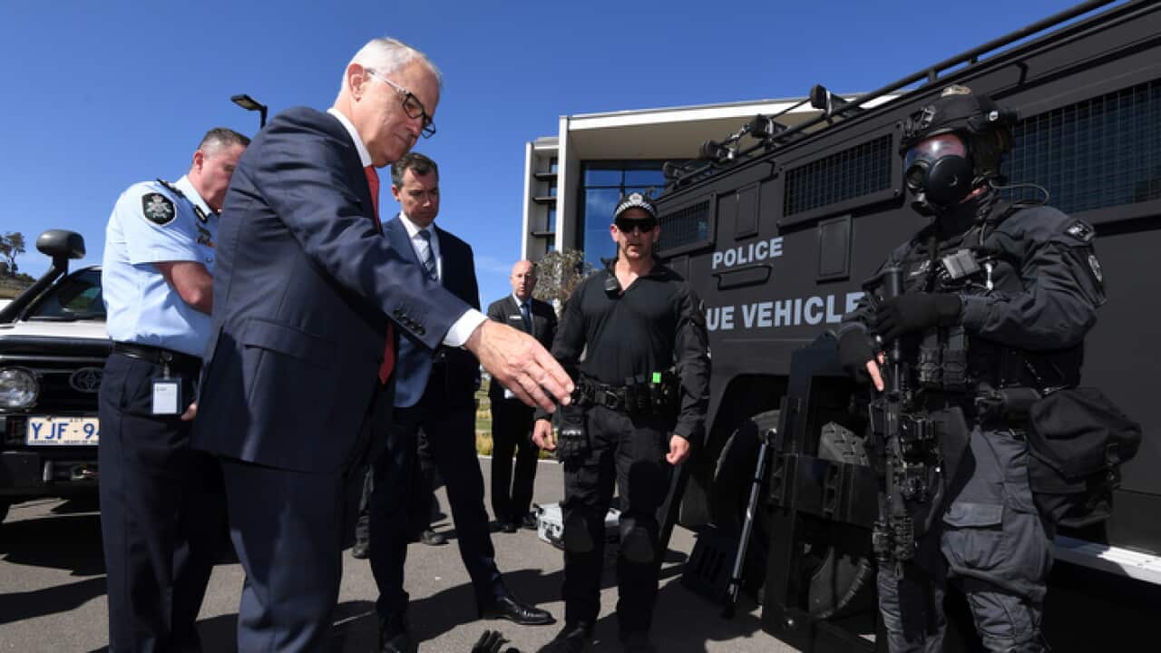 Australian Prime Minister Malcolm Turnbull speaks to members of a Tactical Response Team (TRT) during a tour of the AFP Forensics Facility at Majura in Canberra, Wednesday, October 4, 2017. (AAP Image/Lukas Coch) NO ARCHIVING