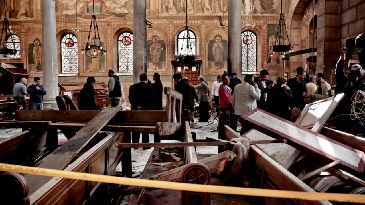 In this Sunday, Dec. 11, 2016, file photo, security forces examine the scene inside the St. Mark Cathedral in central Cairo, following a bombing