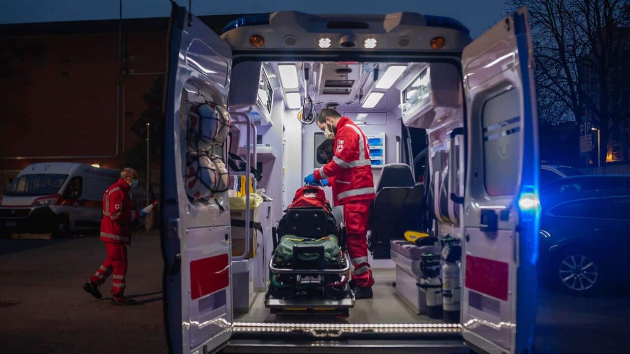 SAN DONATO MILANESE, MILAN, ITALY - 2020/03/27: A Volunteer prepares an ambulance for night service. Due to the Covid-19 emergency, the Crisis Unit of the Red Cross Committee provide help to the citizens who need assistance in several municipalities, they
