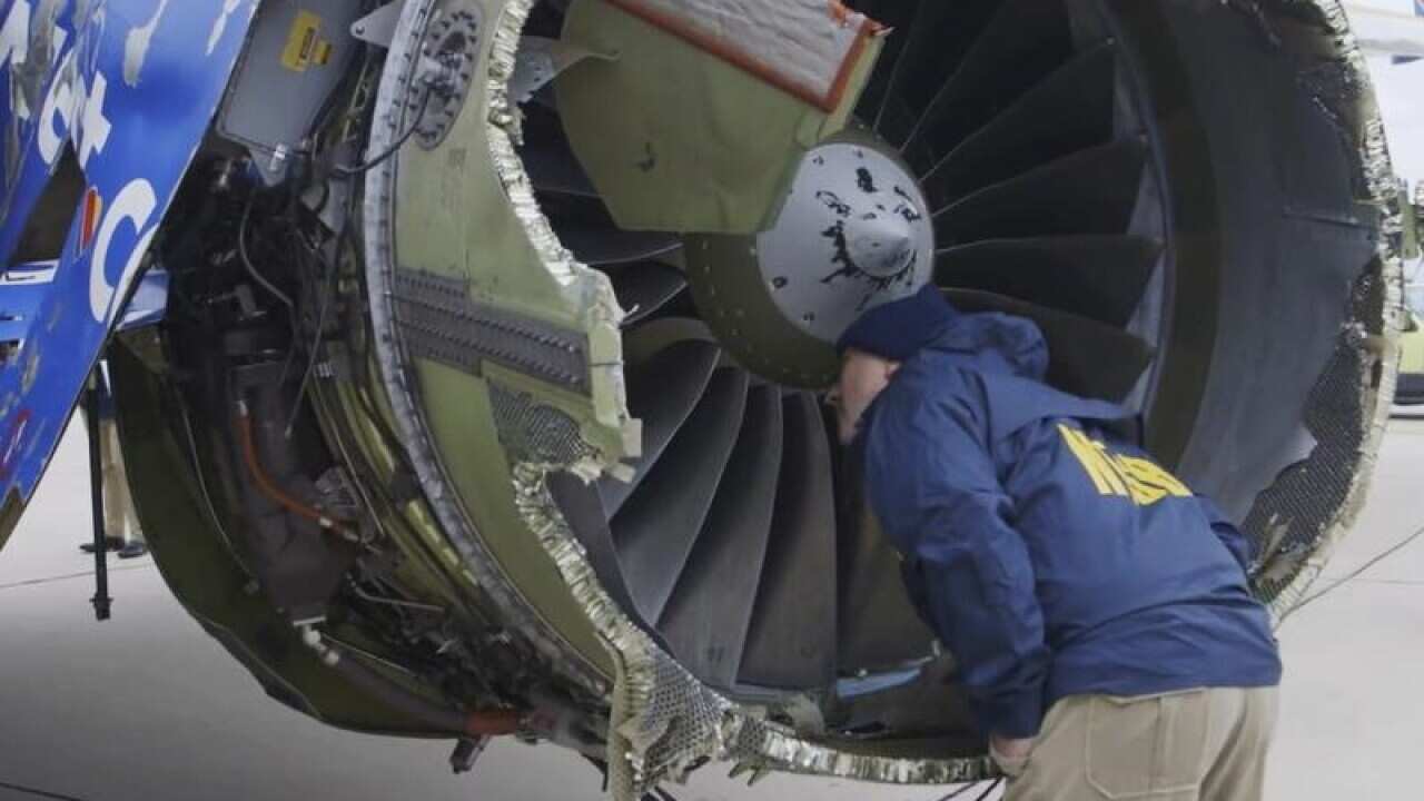 Investigators examine the exploded Southwest Airlines engine.