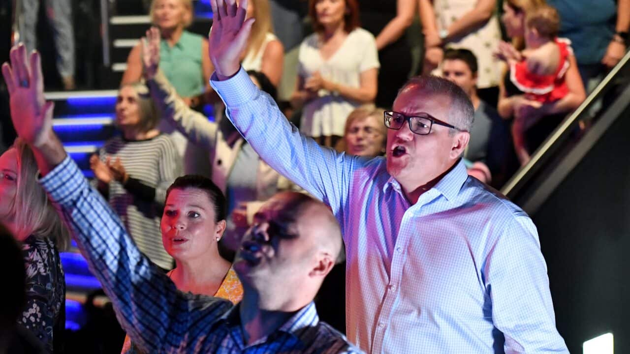 Prime Minister Scott Morrison and wife Jenny sing during an Easter Sunday service at his Horizon Church at Sutherland in Sydney, Sunday, April 21, 2019.
