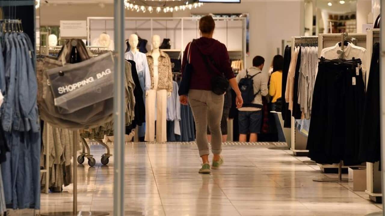 A shopper walks in a women's fashion store
