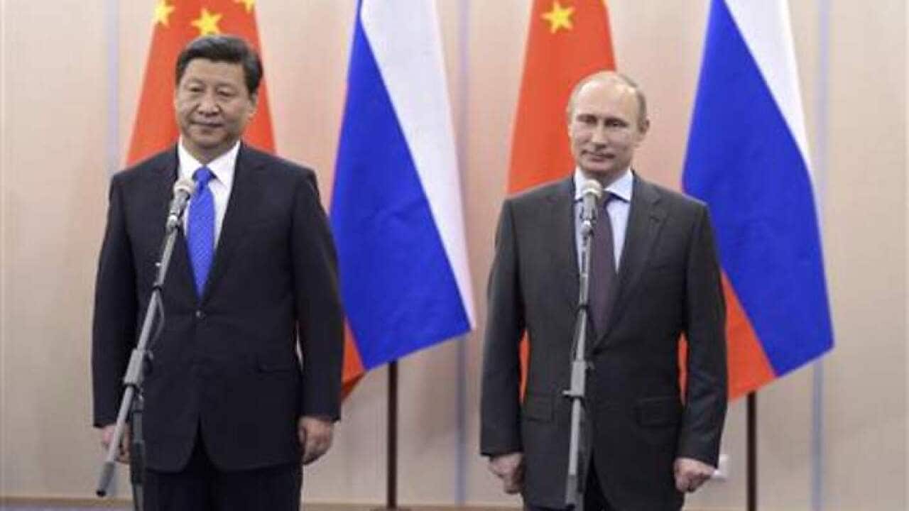 Russia's President Vladimir Putin and Chinese President counterpart Xi Jinping take part in a video link at the Bocharov Ruchei state residence in Sochi