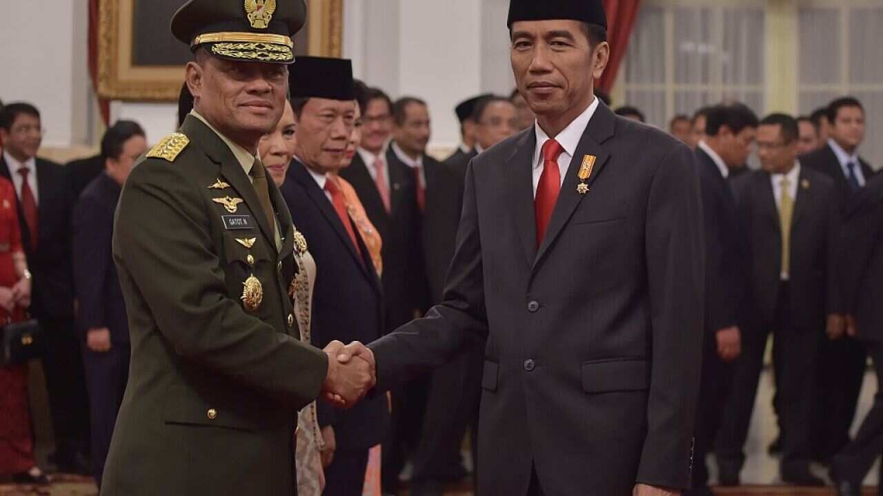 Indonesian President Joko Widodo shakes hands with incoming Indonesian Military Chief General Gatot Nurmantyo