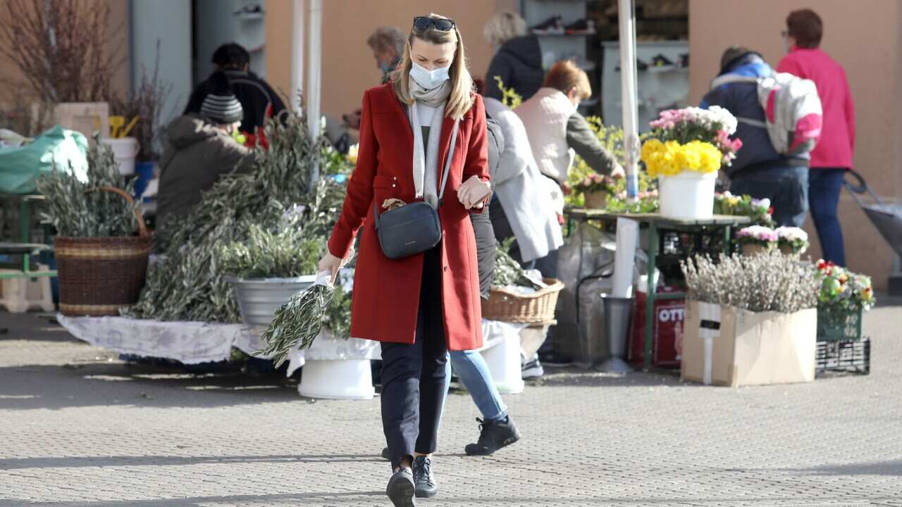 People wearing masks are seen in the city center, in Zagreb, Croatia, on March 26, 2021. It's increasingly likely that there will be no Easter tourism in Croatia this year as the third wave of the COVID-19 pandemic spreads across Europe.