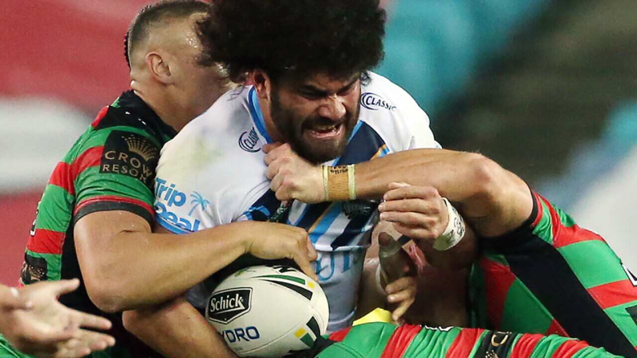 Rabbitohs players tackle Konrad Hurrell of the Titans
