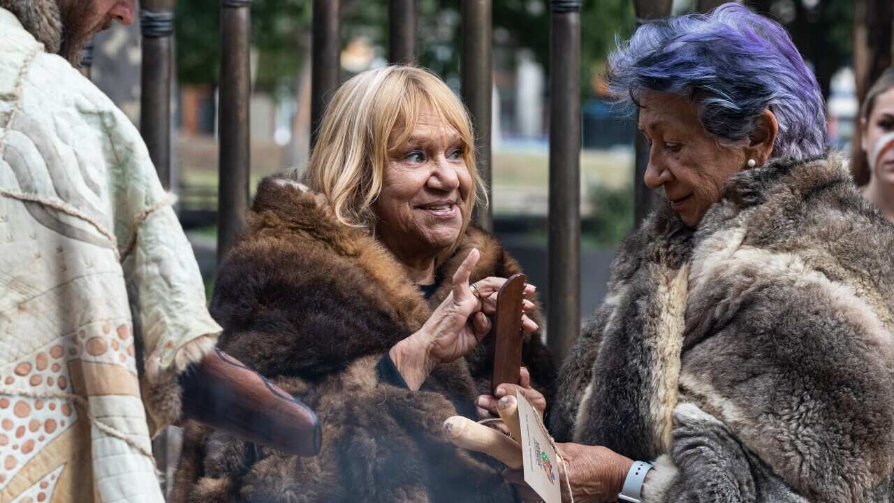 Yoorrook Chair Professor Eleanor Bourke (right) receives an ochre as a cultural exchange gift by Co-Chair of the First Peoples’ Assembly of Victoria, Aunty Geraldine Atkinson.