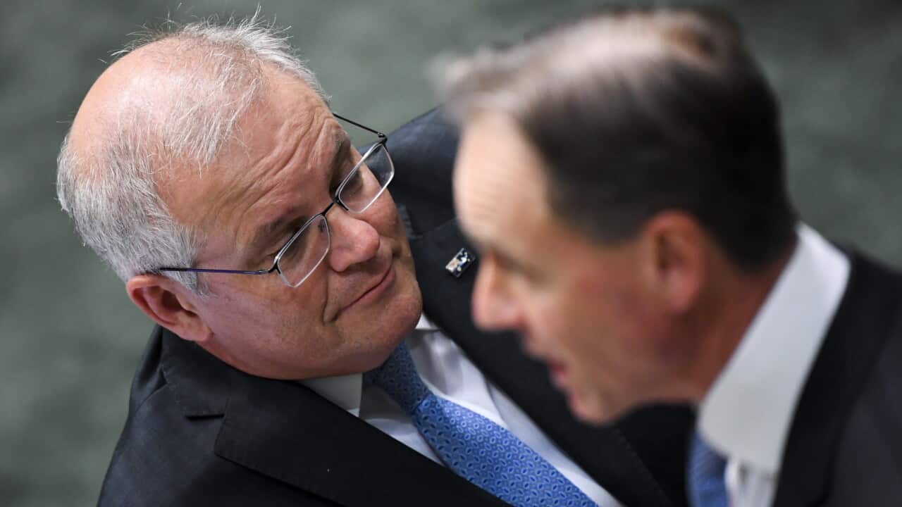 Australian Prime Minister Scott Morrison listens to Australian Health Minister Greg Hunt
