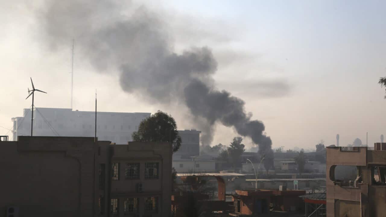 Smoke rises as Iraqi security forces fight against IS militants