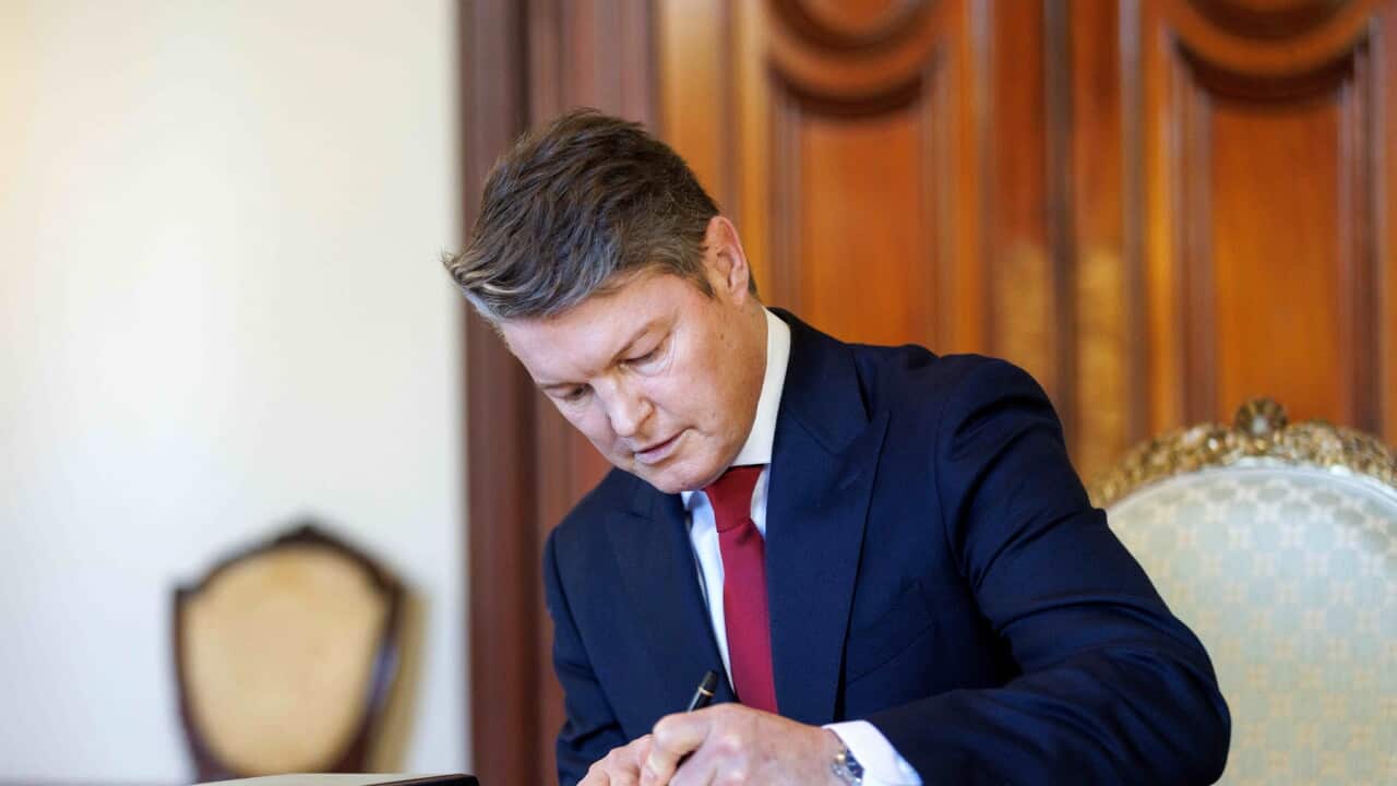 Ben Carroll is signed in as Premier of Victoria at Government House, in Melbourne (AAP).