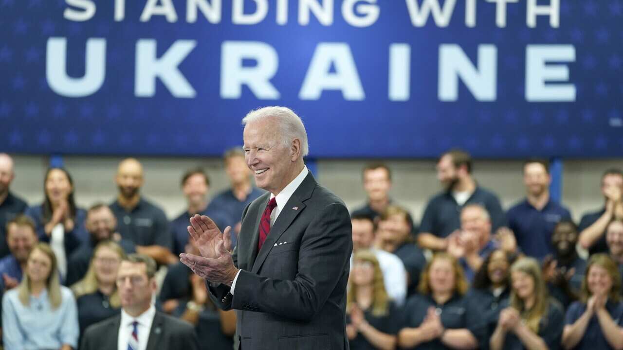 President Joe Biden smiles before speaking on security assistance to Ukraine