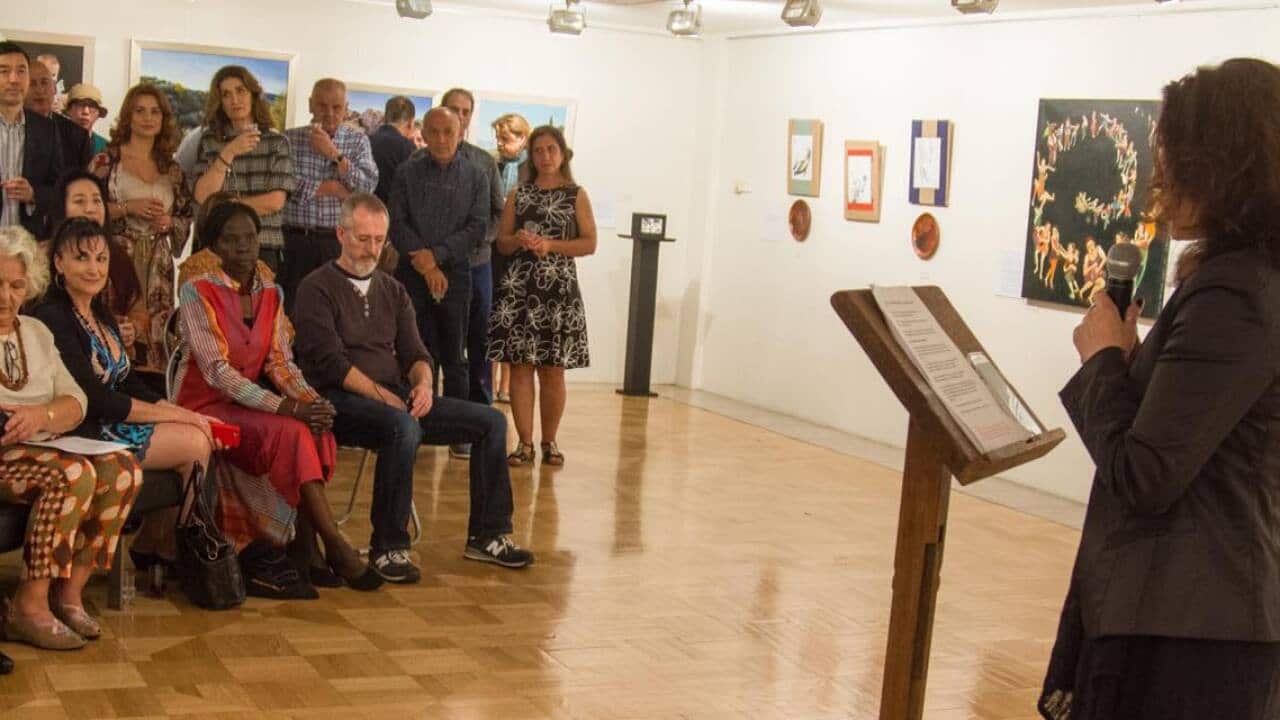 speaker at art exhibition in front of attendees