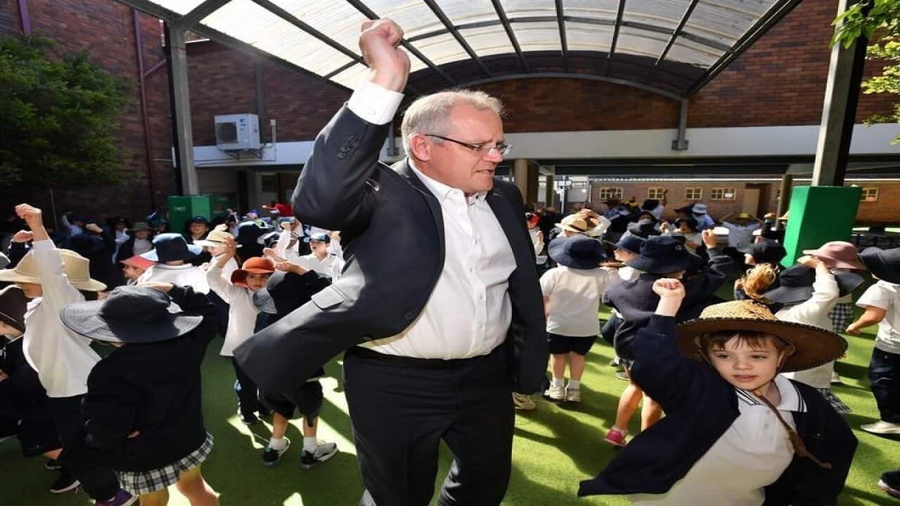Prime Minister Scott Morrison dances with students.