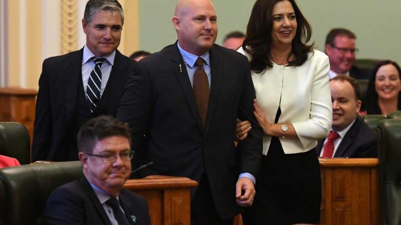 Newly announced Queensland Speaker Curtis Pitt (C) is led to his chair