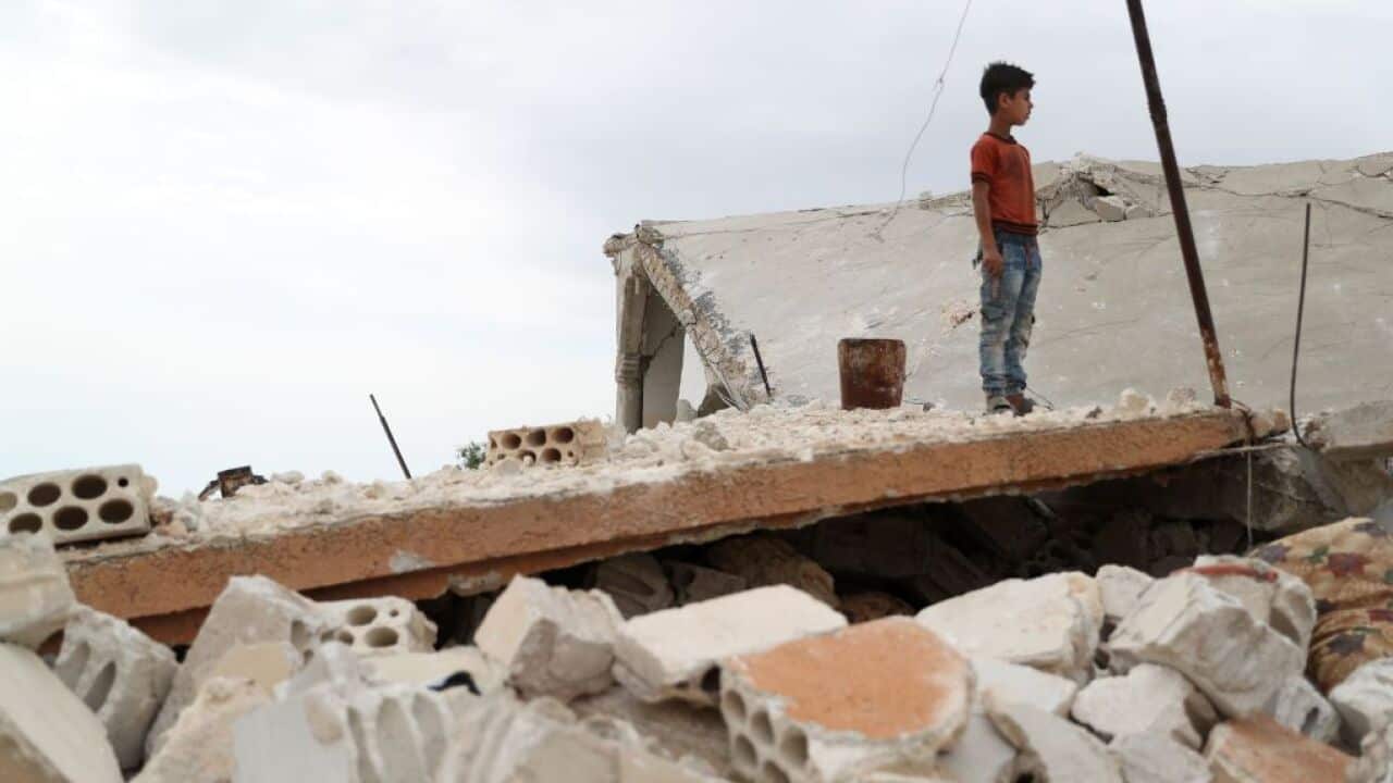 A Syrian boy stands above the rubble of a building in the the jihadist-held Syrian province of Idlib following reported shelling and air strikes in the area.
